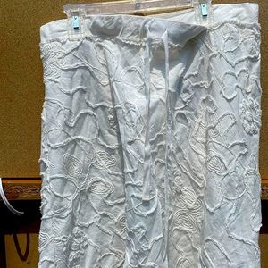 White mid-thigh skirt with raised designs.